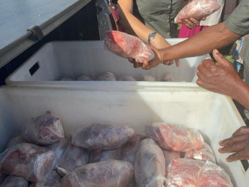 Close up of packaged meat being handed to people