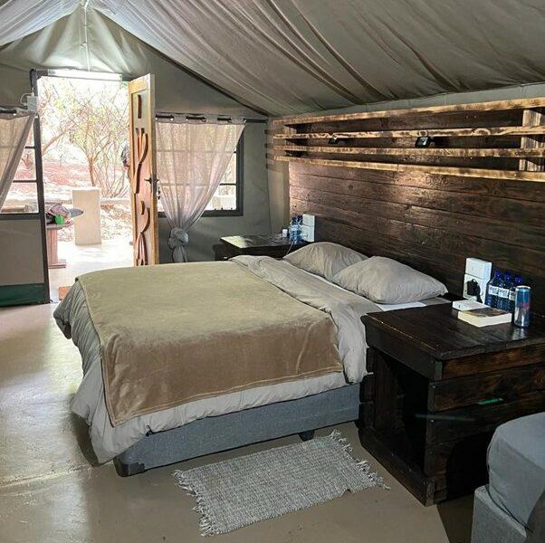 A bedroom in tented accommodation