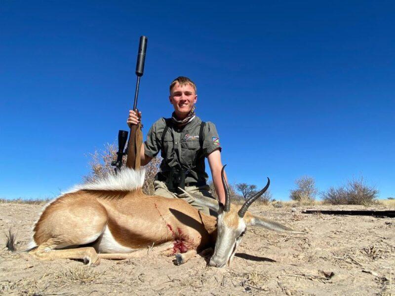 Man with springbok hunting trophy.