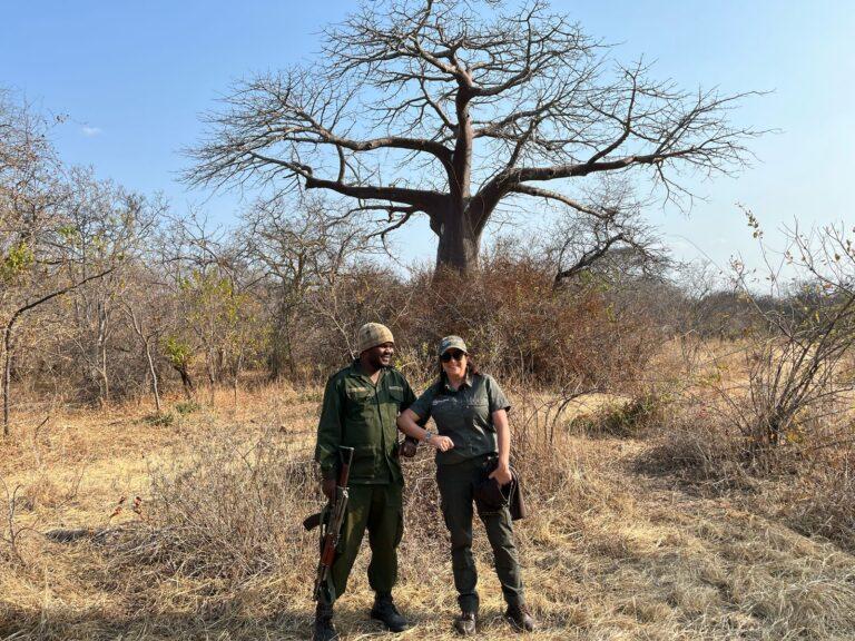 Man and woman posing in front of a tree at Lunda Nkwambi GCA in Tanzania