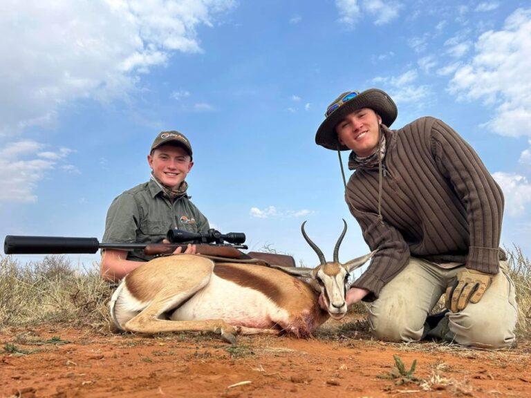 Two hunters with harvested springbok
