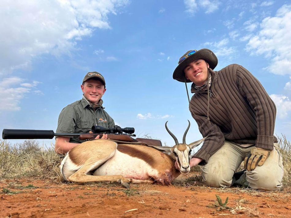 Two hunters with harvested springbok