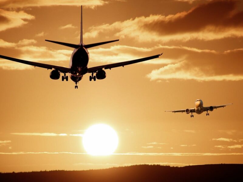 Image of airplanes flying against a sunset