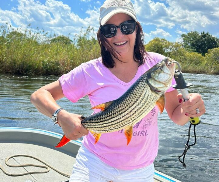 Fishing in the Caprivi Strip, Namibia, after a successful hunting safari landing a hippo bull.