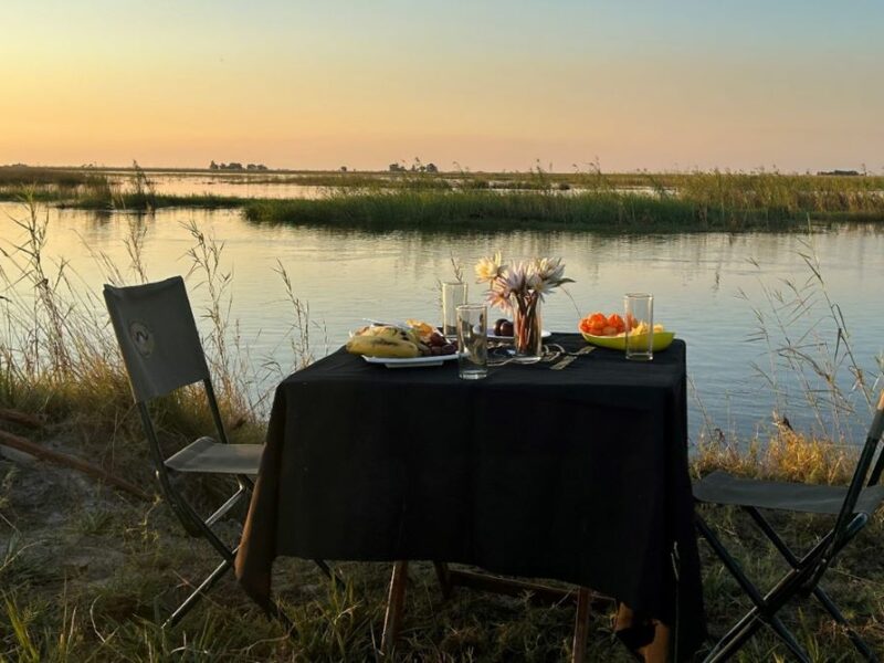 Table laid for breakfast for two, next to the Zambezi River