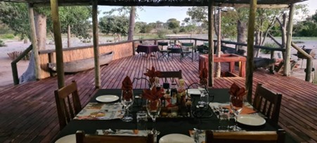 A dining table and chairs in a hunting lodge in Namibia