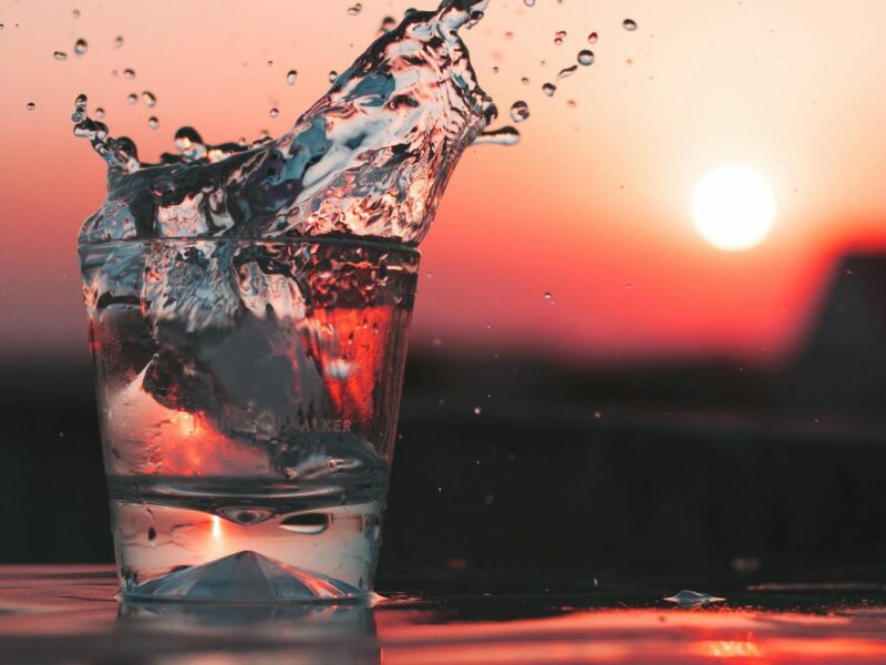 Glass of ice cold water at sunset